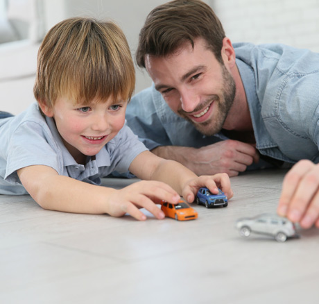 father playing with autistic child using the applied behavior analysis taught by a certified ABA therapist